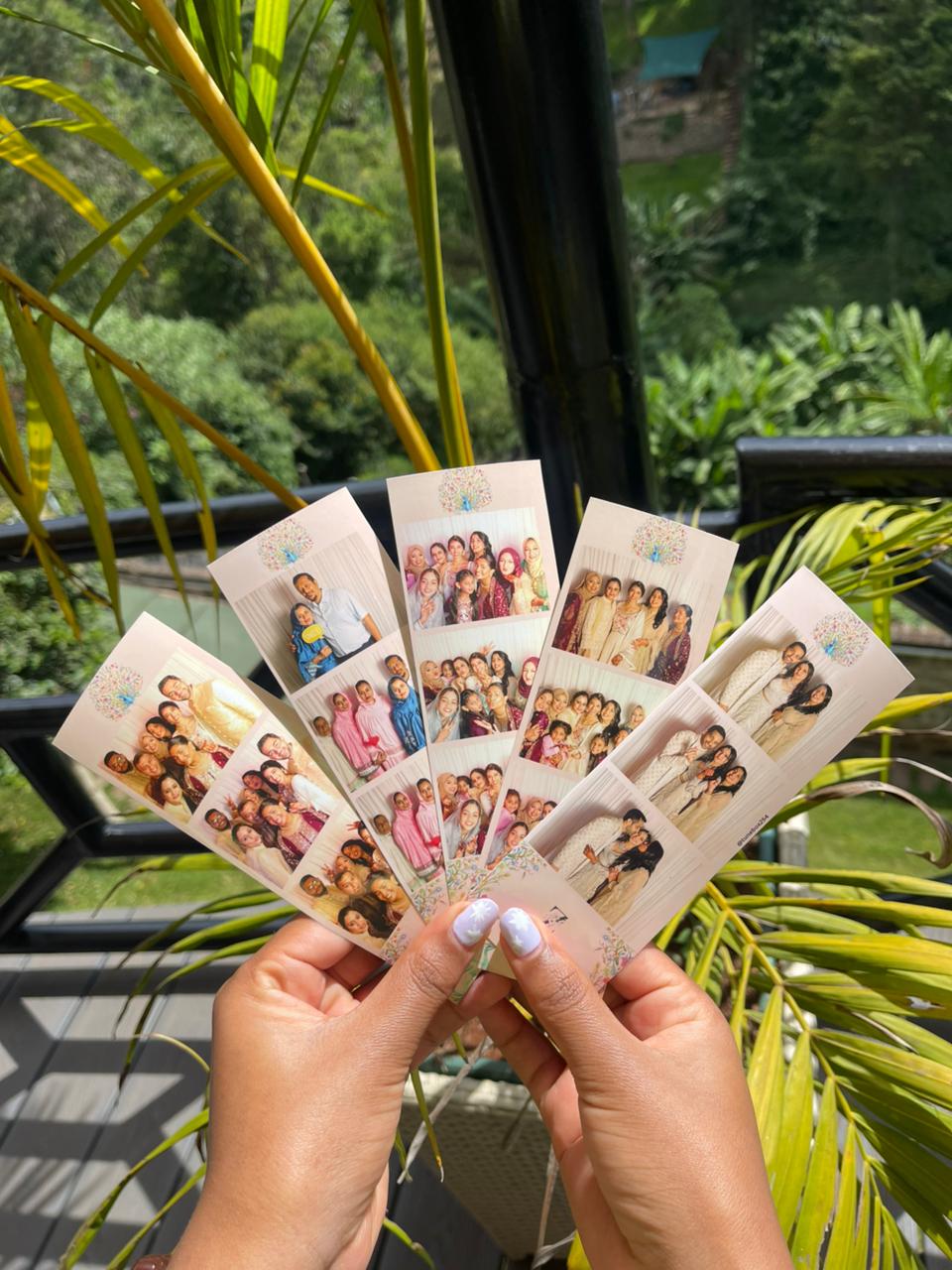A fan of TuneBox photo strips from a celebration