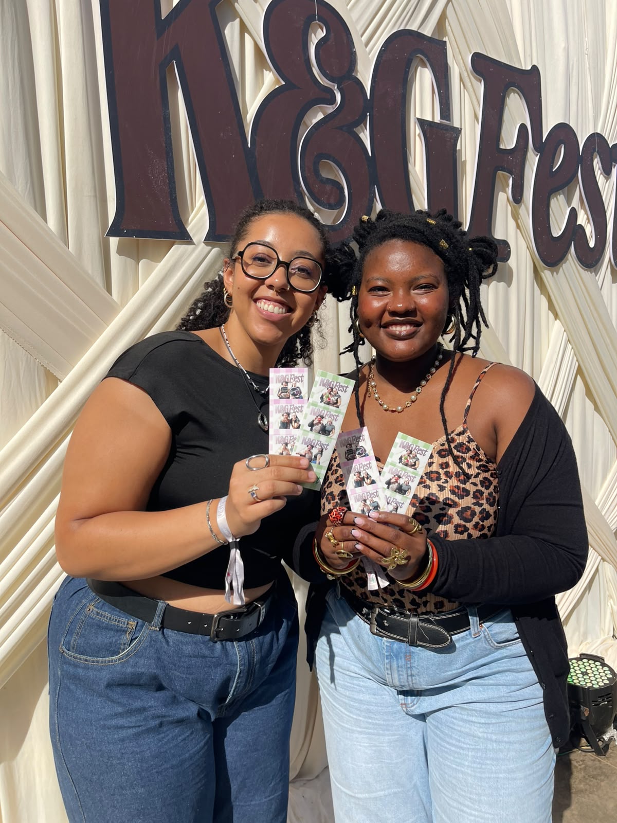 Festival guests holding TuneBox photo strips